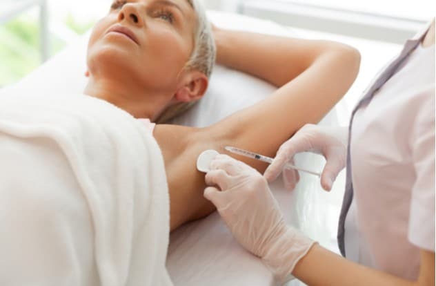 syringe being filled with special liquid for anti sweating treatment